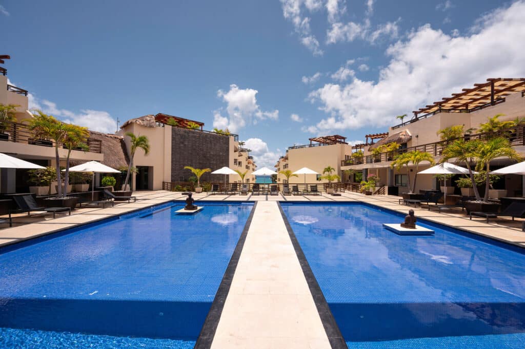 Photo of pool area at Aldea Thai and Caribbean Sea in background