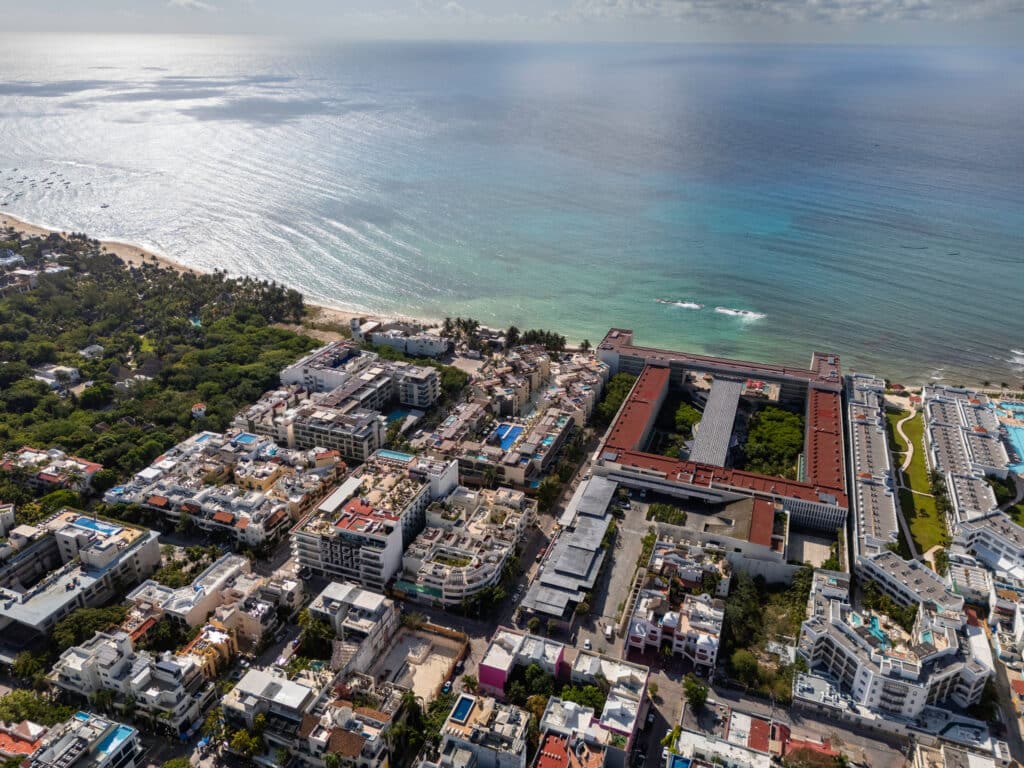 Drone view of Aldea Thai building with the Caribbean Sea in background